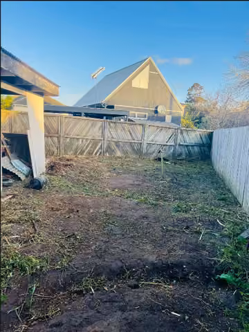 Cleared soil and garden space behind a house