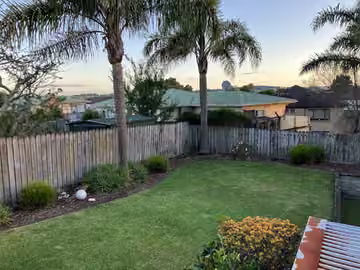 Customer photo of a maintained lawn and garden border