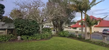 Customer photo of a tidy front garden and lawn
